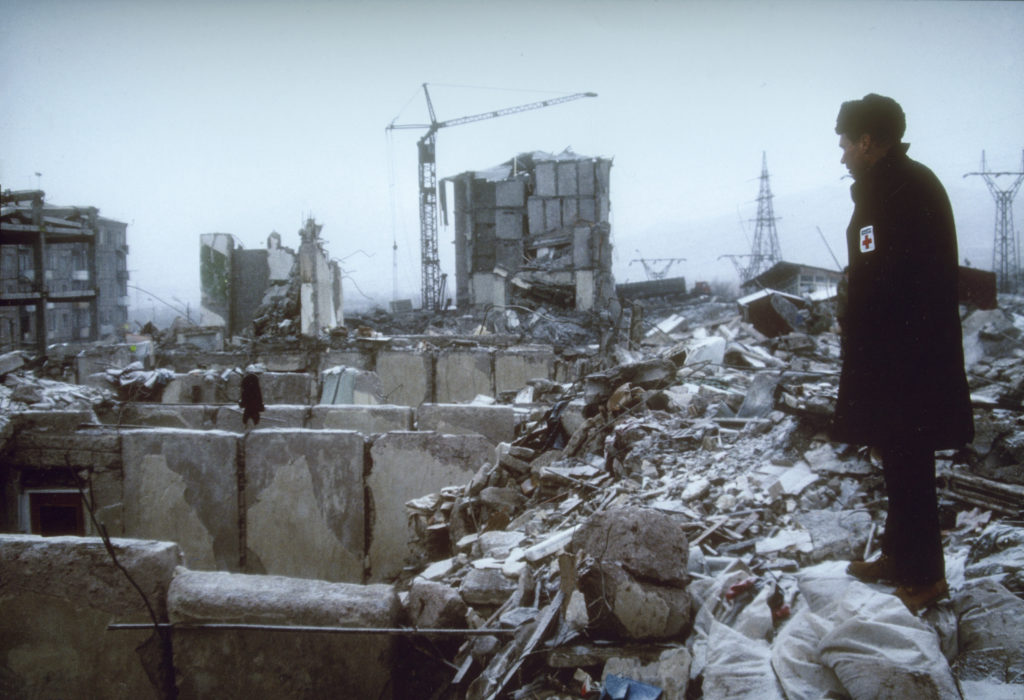 American Red Cross President Dick Schubert surveys the damage following the Spitak earthquake.