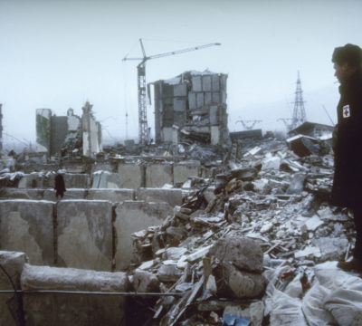 American Red Cross President Dick Schubert surveys the damage following the Spitak earthquake.