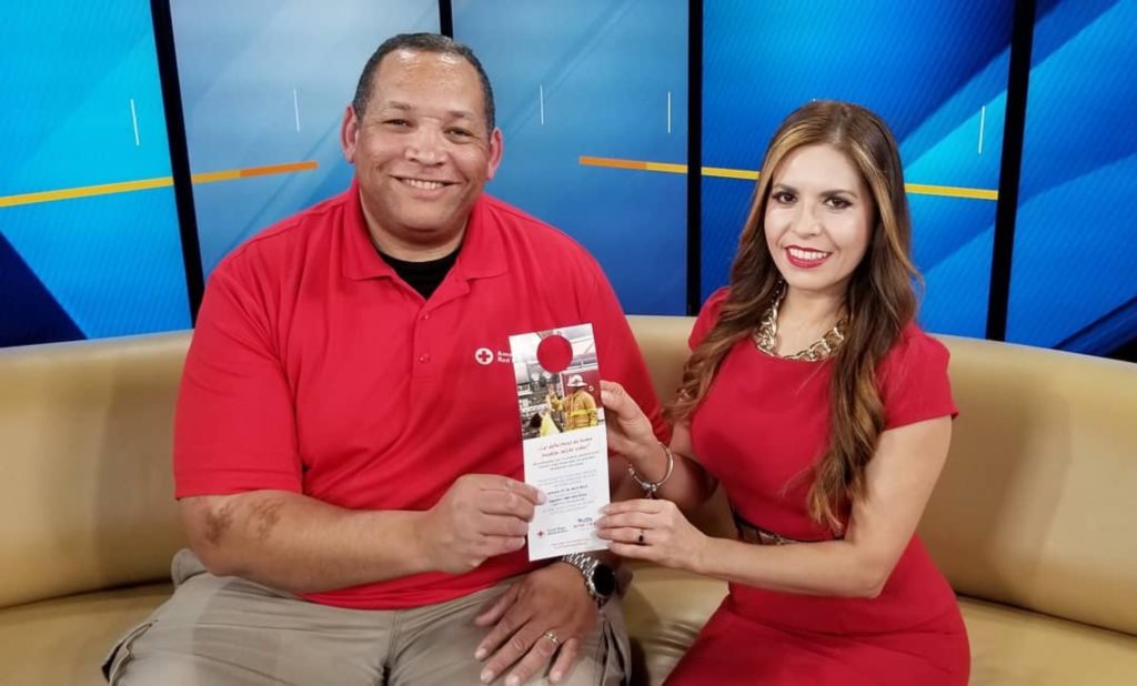 AJ sitting with a news correspondent after an interview.